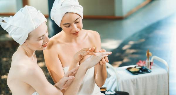 Women enjoying a spa day while receiving hand rejuvenation treatment.